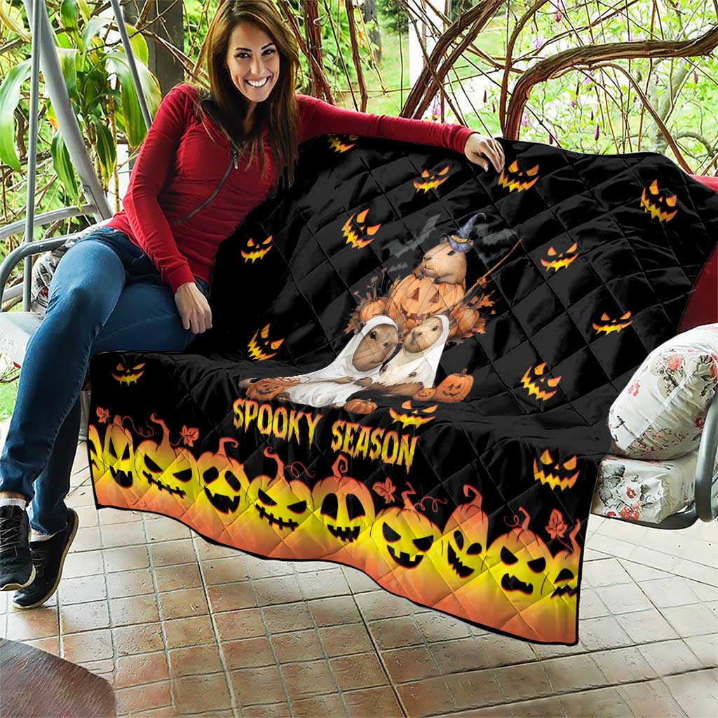Black Halloween quilt with quilted diamonds, orange jack-o-lantern icons, and 'Spooky Season' print