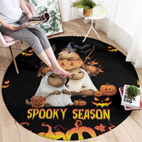 Black round Halloween carpet on floor with animals, pumpkins, and 'Spooky Season' wording