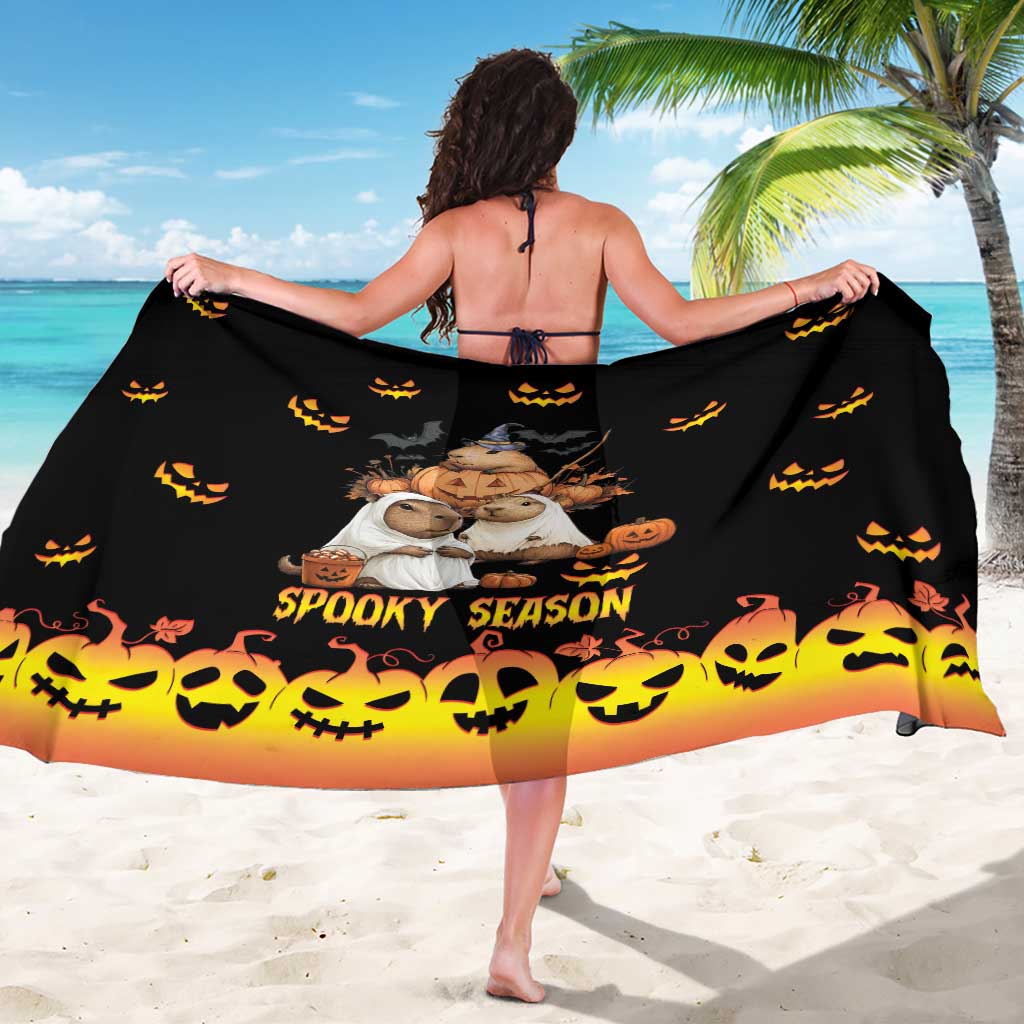 Black sarong wrap with central animal graphic, spooky banner, and jack-o-lantern trim