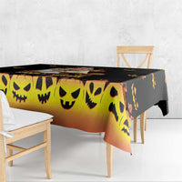 Halloween tablecloth, orange gradient with black smiling jack-o’-lantern faces