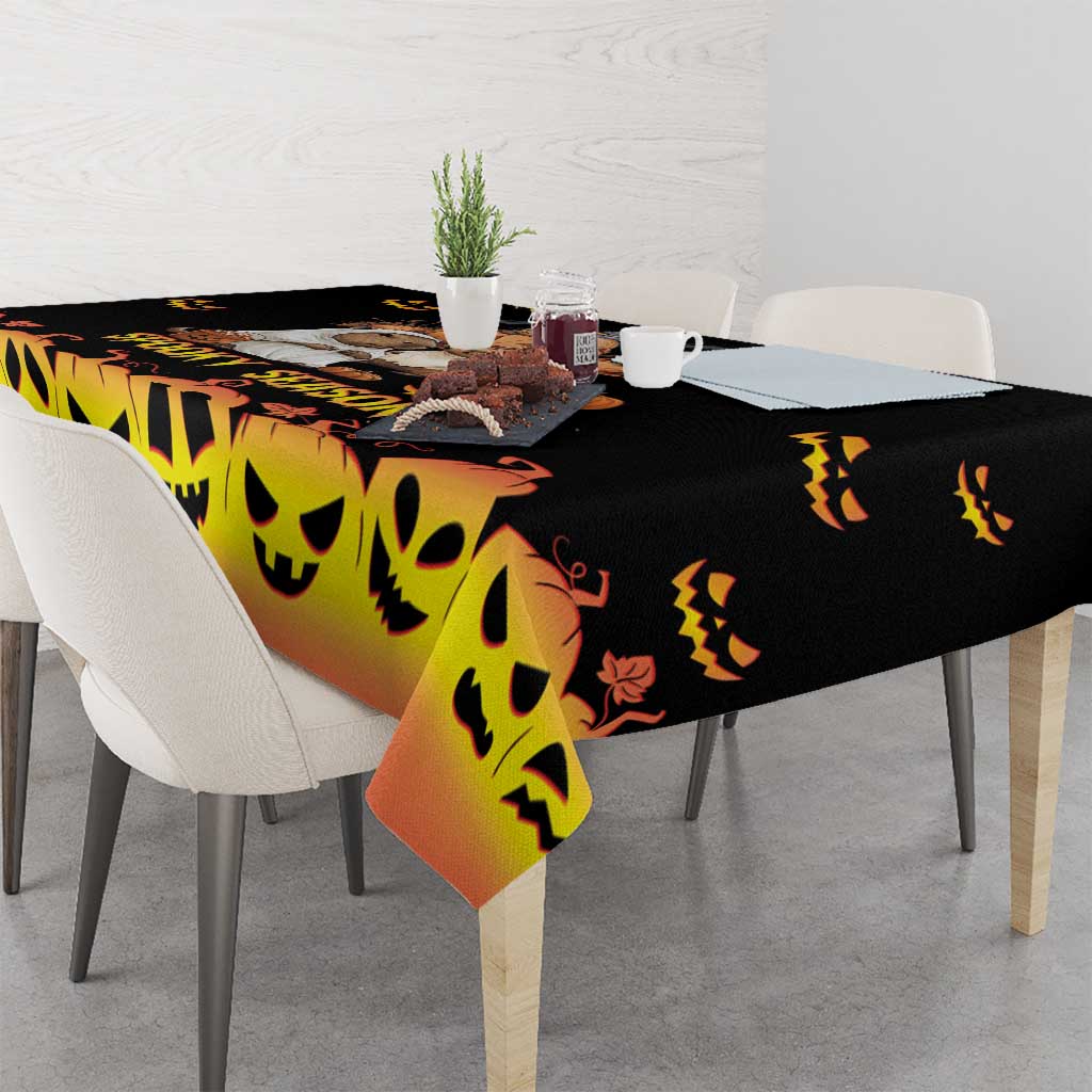 Halloween tablecloth, orange-to-black gradient with smiling pumpkin face pattern