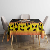 Halloween tablecloth, black and yellow smiling jack-o’-lantern pattern on square table