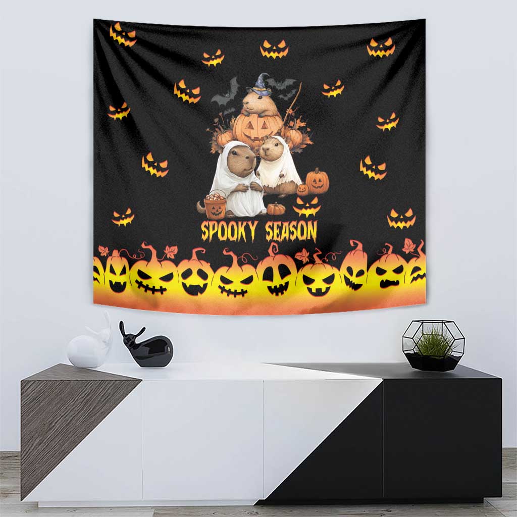 Black Halloween tapestry with central character trio, 'Spooky Season' text, and orange skull-and-pumpkin strip