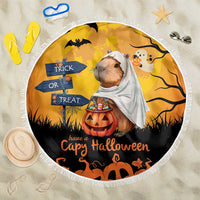 Round beach blanket in orange with capybara ghost, jack-o'-lantern, and “Have a Capy Halloween”