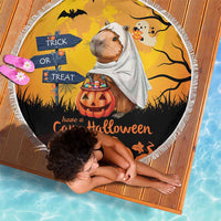 Round orange beach blanket with capybara ghost, trick-or-treat signs, and fringed edge
