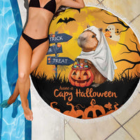 Orange round beach blanket with capybara ghost, Halloween pumpkins, and fringed border