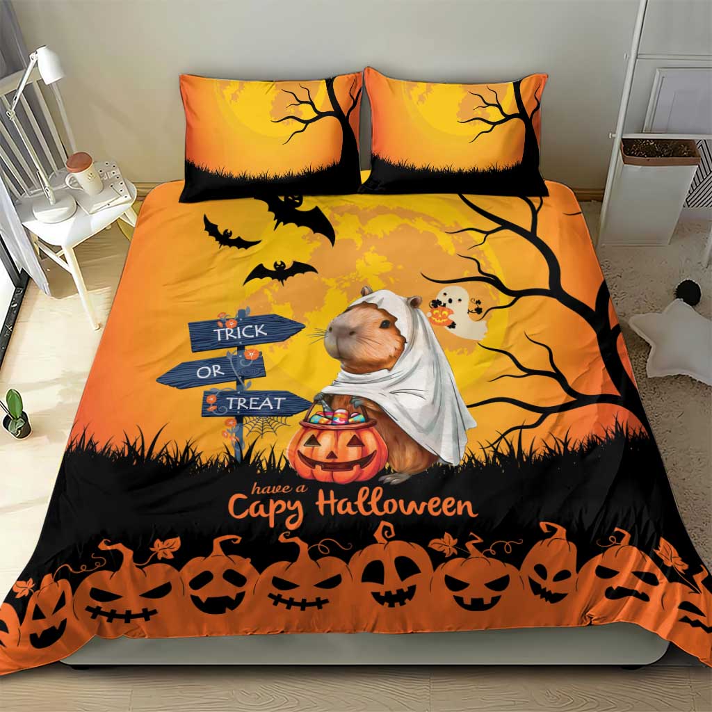 Orange Halloween bedding set with two pillows; capybara ghost, “Trick or Treat” sign and pumpkins
