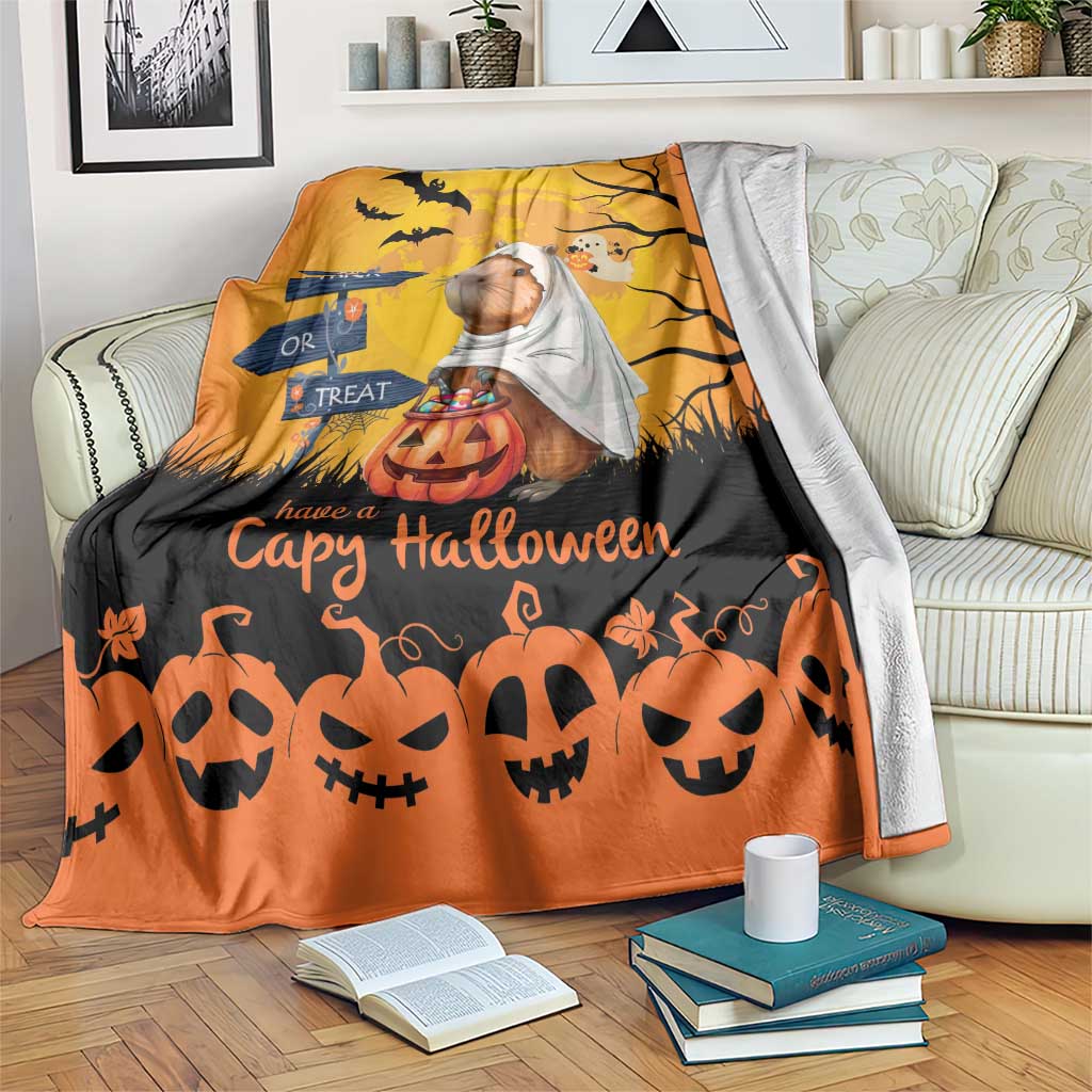 Orange Halloween capybara ghost throw blanket with pumpkins, bats, and 'Trick or Treat' sign