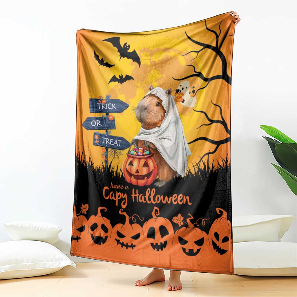 Orange Halloween capybara ghost blanket draped with pumpkins, bats, and jack-o-lantern border