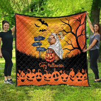 Orange and black Halloween capybara ghost quilt, spread across backyard