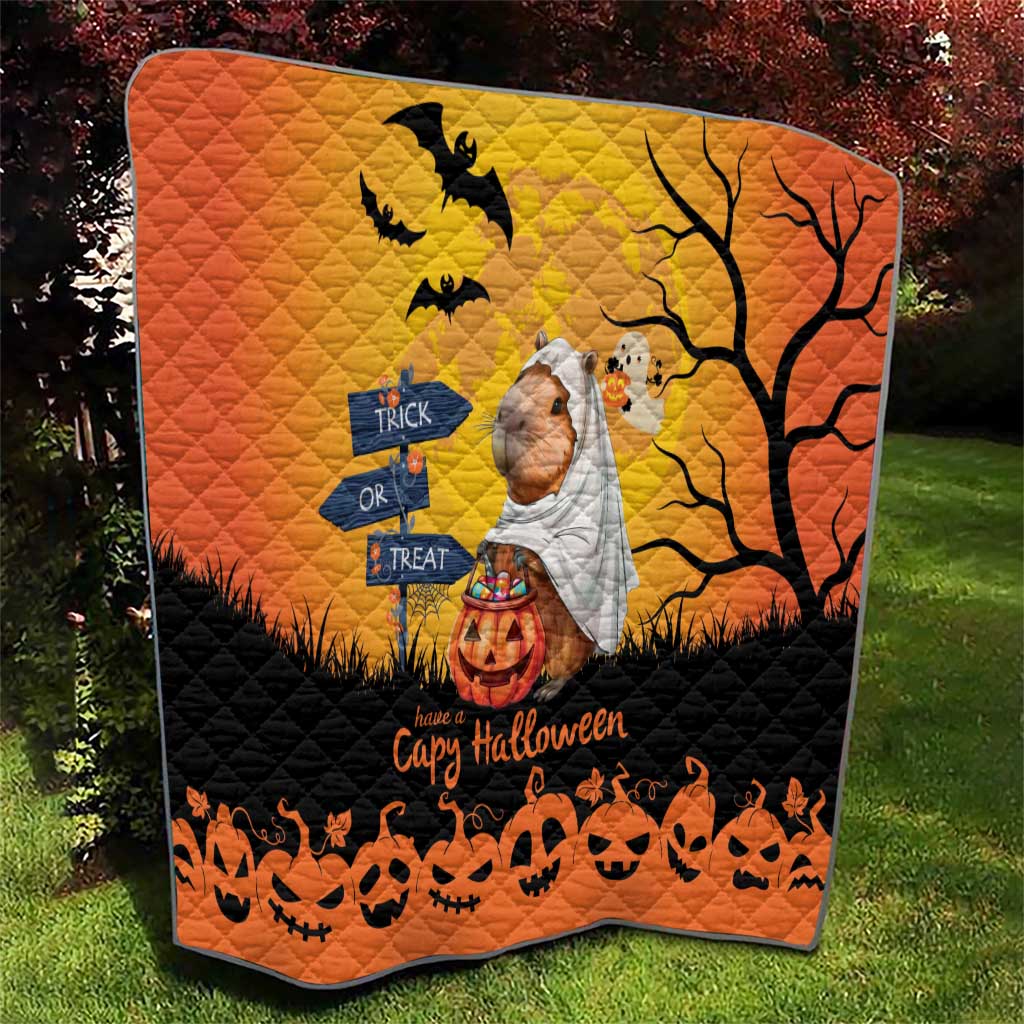 Orange Halloween capybara ghost quilt with bats, tree branches, and pumpkins