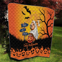Orange Halloween capybara ghost quilt with bats, tree branches, and pumpkins