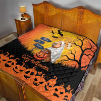 Orange and black Halloween capybara ghost quilt on a wooden bed