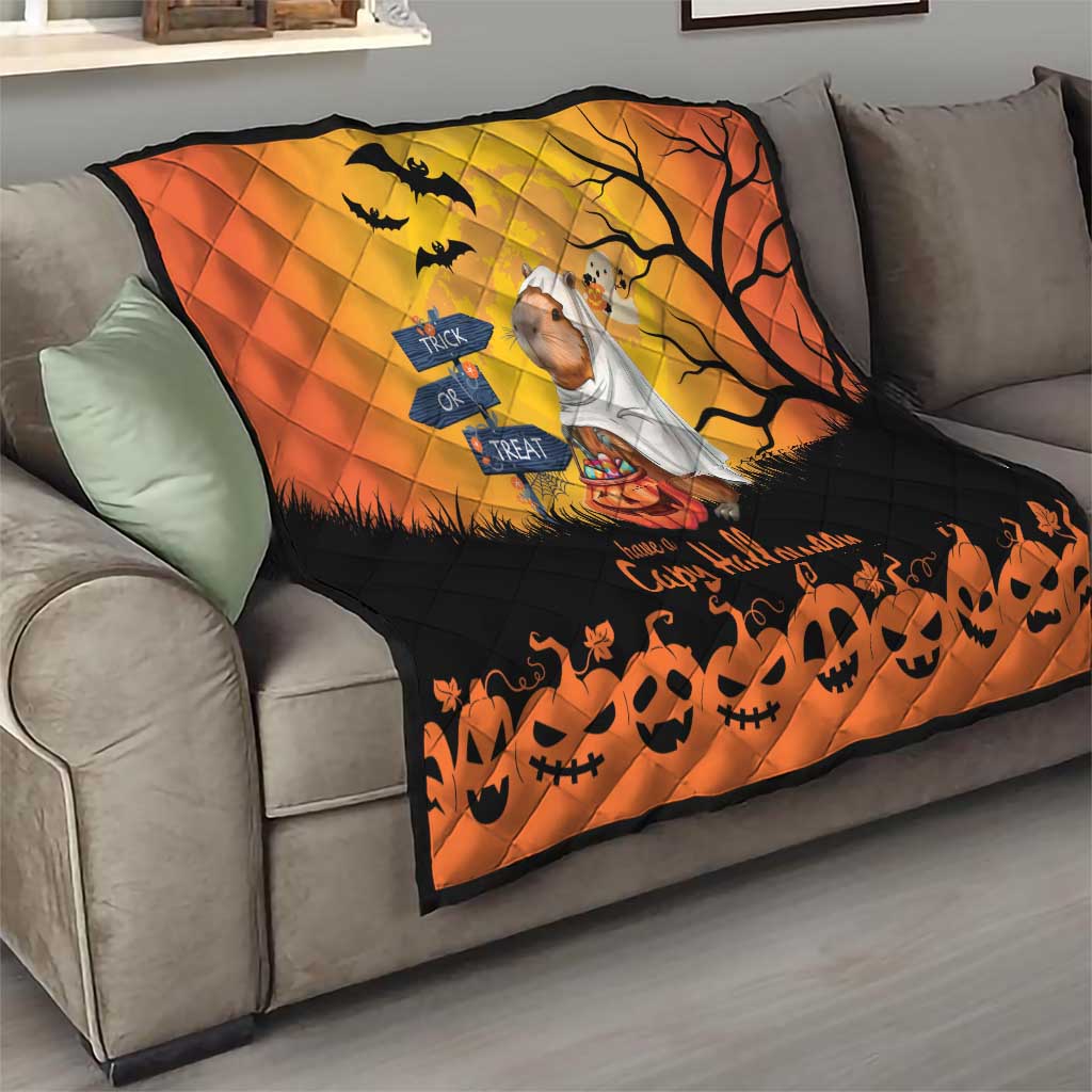 Orange and black Halloween capybara ghost quilt on a living room sofa