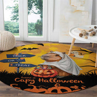 Round orange Halloween rug with capybara ghost face, jack-o’-lantern, and Trick or Treat lettering