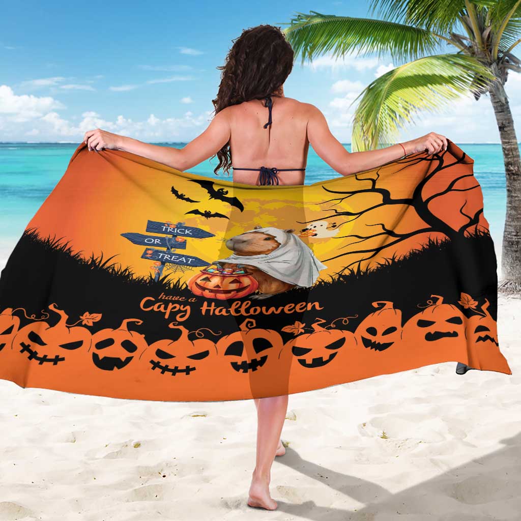 Orange Halloween sarong with black bat border and capybara-ghost illustration