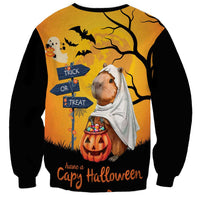 Unisex orange Halloween sweatshirt, capybara ghost in front of trick-or-treat sign art