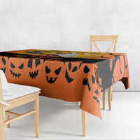 Orange Halloween tablecloth with black jack-o-lantern face pattern