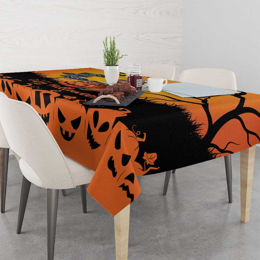 Orange Halloween tablecloth draped over dining table with jack-o-lantern pattern