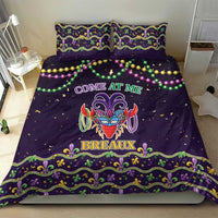 Purple bedding set with two pillows featuring carnival mask center and green-gold fleur-de-lis trim