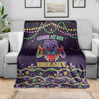 Dark purple Mardi Gras throw blanket with central jester mask, COME AT ME, BREAUX, and fleur-de-lis border