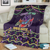 Dark purple Mardi Gras throw blanket with jester face graphic, COME AT ME, BREAUX, and green-gold trim