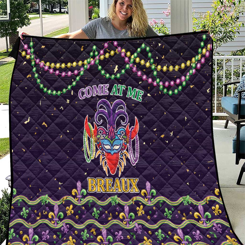 Black quilt with colorful Mardi Gras bead garland and fleur-de-lis mask graphic