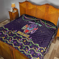 Black quilt draped on wooden bed, featuring Mardi Gras mask and “Breaux” title