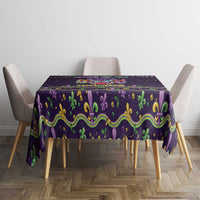 Mardi Gras tablecloth on square dining table with purple, green and gold swirls