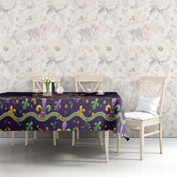 Mardi Gras tablecloth on long table with purple, green and gold ornate border
