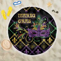 Round black beach blanket with Mardi Gras mask graphic and bead pattern, white fringe edge