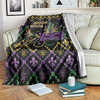 Black geometric blanket with purple Mardi Gras mask, fleur-de-lis, bead trim, 'MARDI GRAS'.
