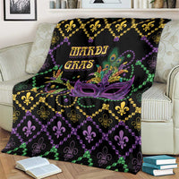 Black geometric Mardi Gras blanket draped on sofa, purple mask, gold fleur-de-lis border.