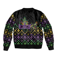 Black unisex bomber jacket with central Mardi Gras mask design and fleur-de-lis hem