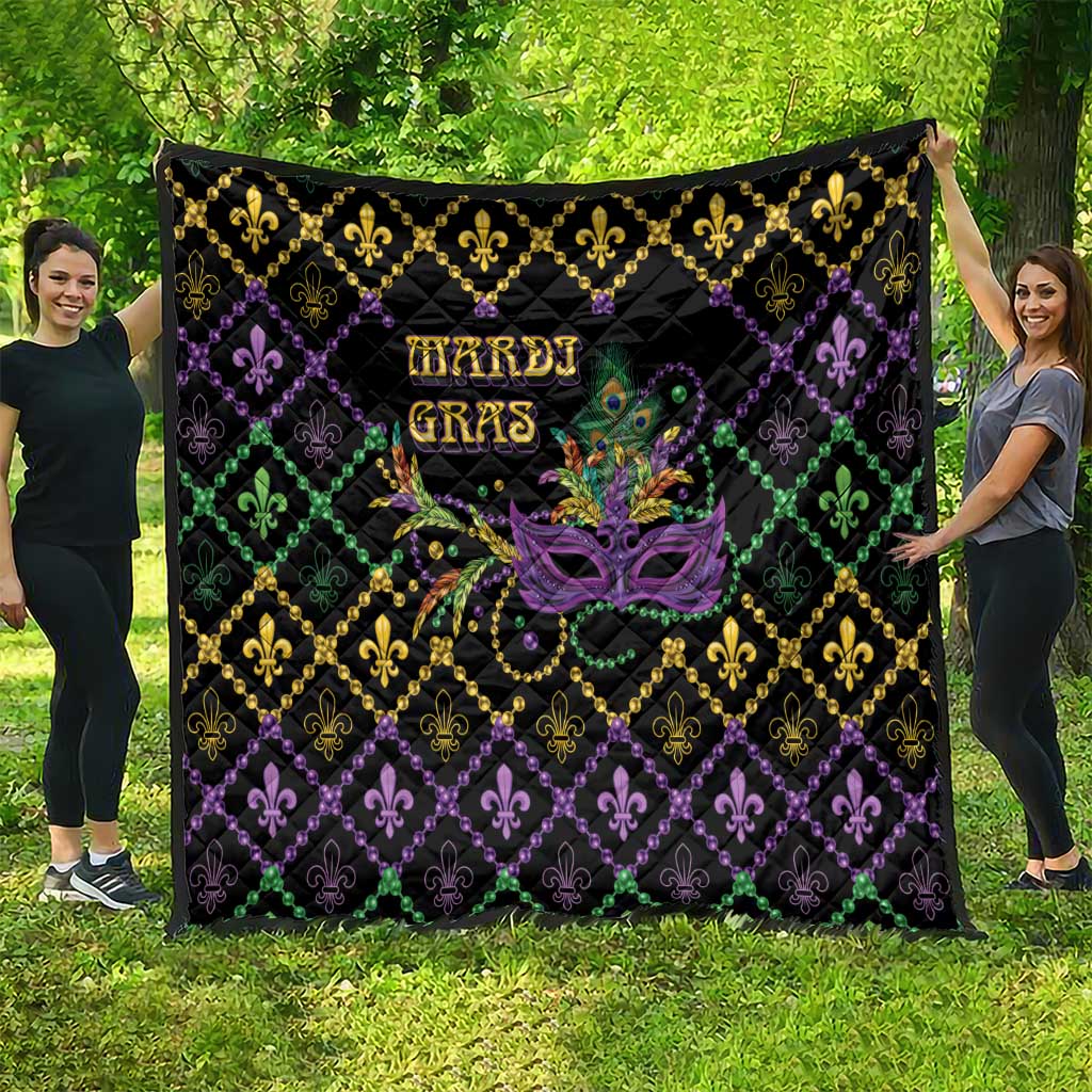 Mardi Gras quilt with geometric diamond pattern on black, fleur-de-lis and mask graphic