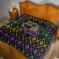Mardi Gras quilt on bed, black with purple and green fleur-de-lis diamonds and mask