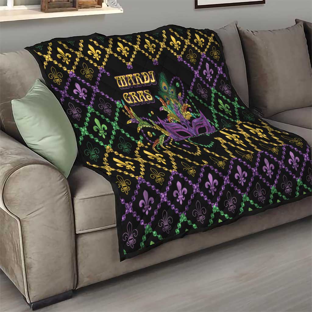 Mardi Gras quilt on sofa, black geometric pattern with purple, green, gold fleur-de-lis