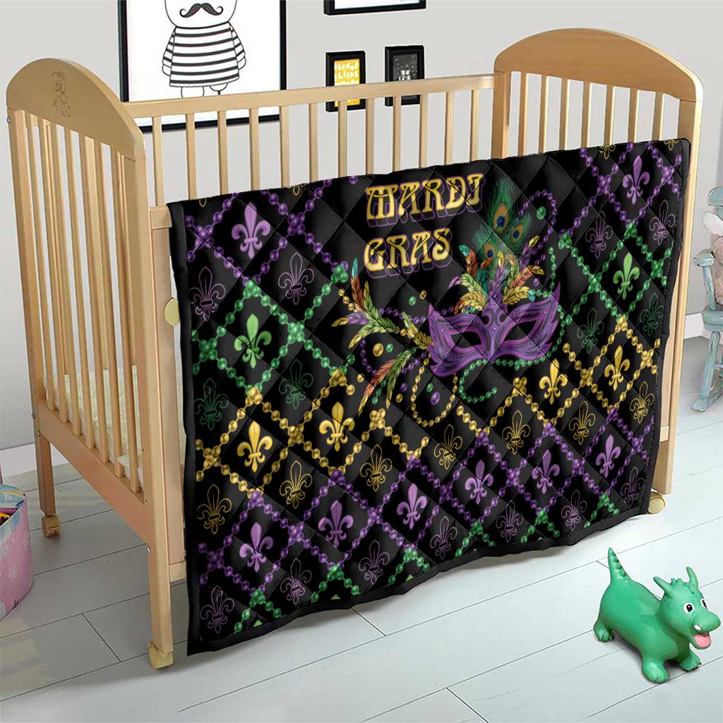 Mardi Gras quilt in crib, black with purple, green, gold fleur-de-lis diamonds and mask