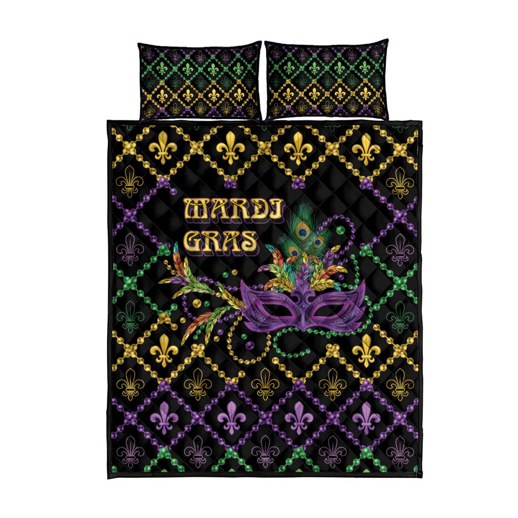 Black quilt bed set with matching pillows; purple, green, and gold fleur-de-lis mask motif