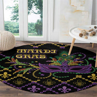 Black round Mardi Gras carpet with purple mask center and gold-and-green fleur-de-lis border