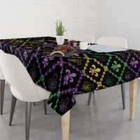 Black tablecloth with Mardi Gras fleur-de-lis motif in purple, green, and gold; draped ends