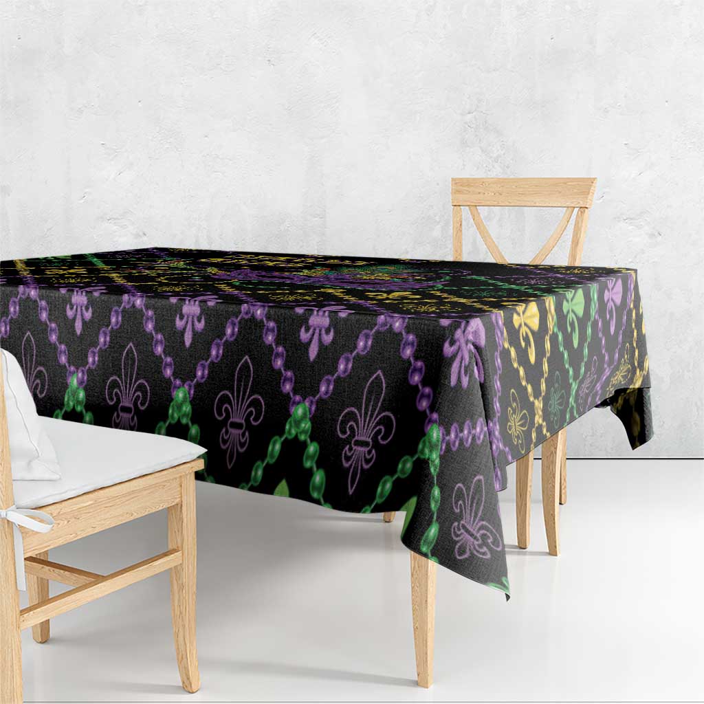 Black Mardi Gras tablecloth with purple, green, and gold fleur-de-lis geometric border