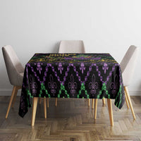 Rectangular black Mardi Gras tablecloth featuring purple and green fleur-de-lis icons with gold dots