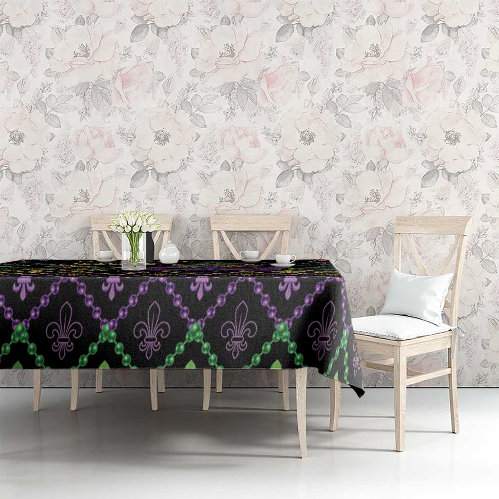 Black geometric Mardi Gras tablecloth with purple beads, green accents, and gold fleur-de-lis