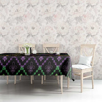 Black geometric Mardi Gras tablecloth with purple beads, green accents, and gold fleur-de-lis
