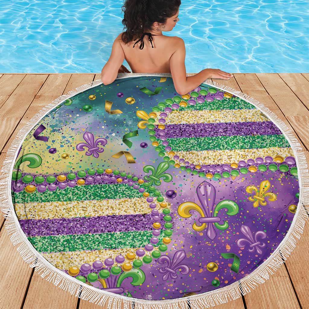 Round beach blanket with purple fleur-de-lis motif, green and gold glitter stripes, white fringe