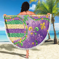 Round beach blanket with purple background, fleur-de-lis icons and glitter stripes, white fringe