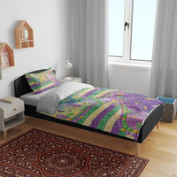 Purple bedding set on bed with fleur-de-lis glitter bead pattern and colorful striped design, 2 pillow covers