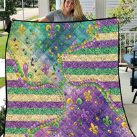 Fleur-de-lis quilt in purple, teal, and gold with striped pattern and bead accents