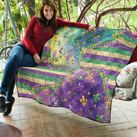 Fleur-de-lis quilt showing purple and teal fields with gold stripes and bead accents